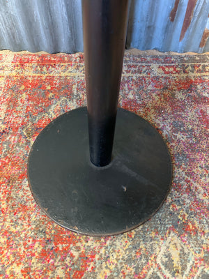 A cast iron table with circular marble top
