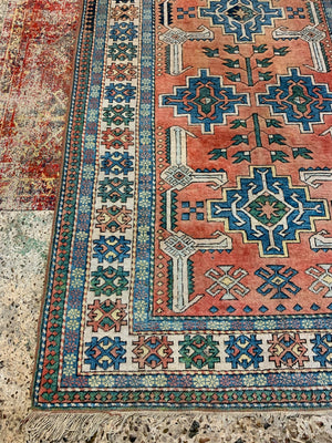 An orange and blue rectangular Persian rug