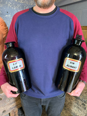 A pair of very large amethyst glass apothecary bottles