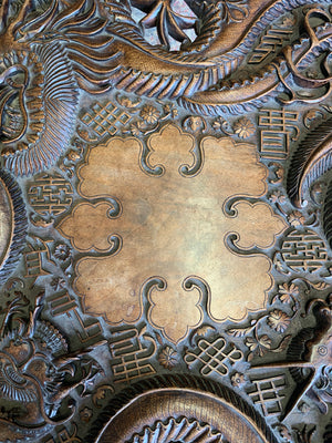 A profusely carved dragon table