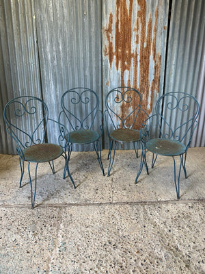 A set of four French blue wire work garden chairs