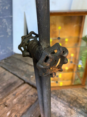 A rusty black metal adjustable vintage industrial floor lamp