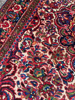 A red ground Heriz Persian rug - 206cm x 145cm