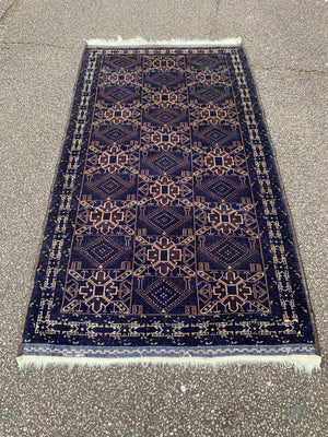 A midnight blue ground rug - 217cm x 115cm