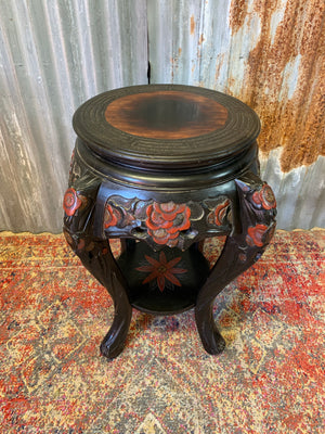 A Chinese ebonised carved stand