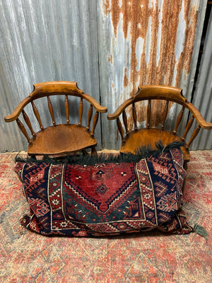 A large rectangular Persian carpet floor cushion