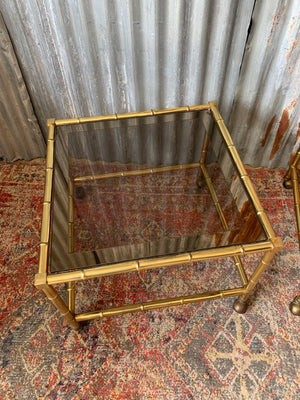 A pair of brass and glass Hollywood Regency faux bamboo tables