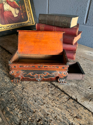 A carved wooden Chinese box with dragon motifs