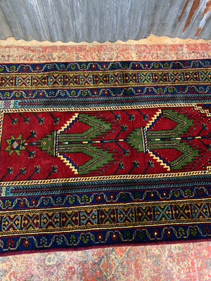 A red ground Persian rectangular rug with niche design - 208cm x 102cm