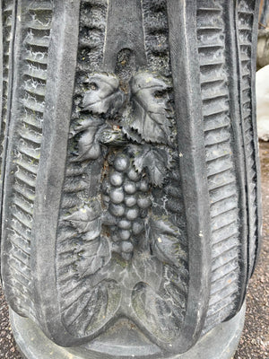 A cast stone round top pedestal garden table