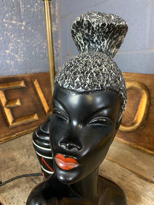A black African woman figural table lamp