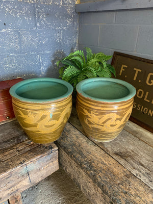 A pair of glazed earthenware dragon ‘egg’ pots