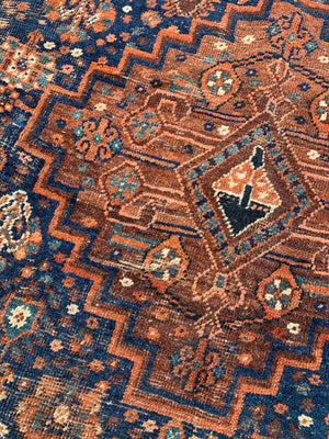 A very large hand woven Persian blue and orange rectangular rug- 300cm x 225cm