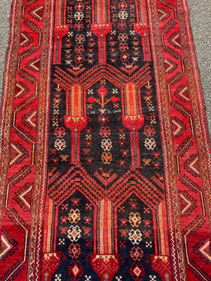 A red ground Persian rectangular rug with niche design- 239cm x 111cm
