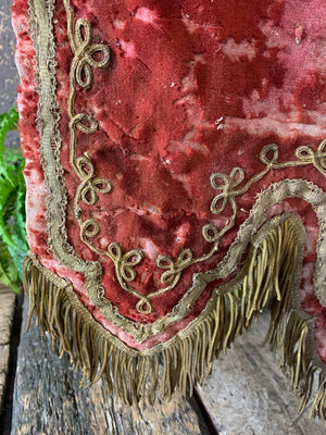 An embroidered red velvet wall hanging