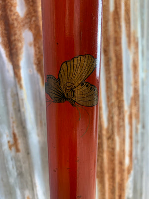A red lacquer chinoiserie standard lamp with tasselled shade