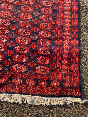 A silk red ground Bokhara rug - 204cm x 105cm