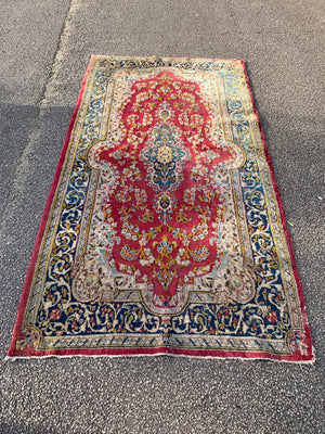 A fuchsia ground Persian rectangular rug