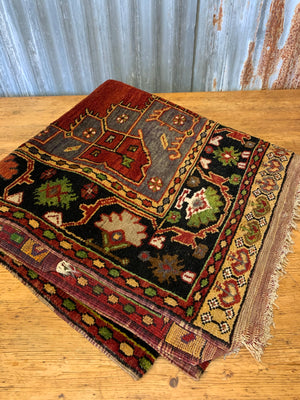A large hand woven Persian red ground rectangular rug