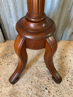 A mahogany sculpture display stand