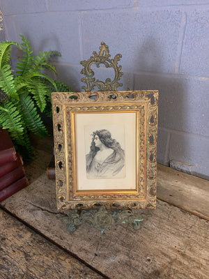 An Art Nouveau framed and signed pencil portrait of a woman