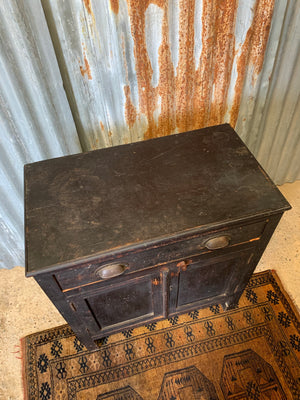 A small black ebonised cupboard with single drawer