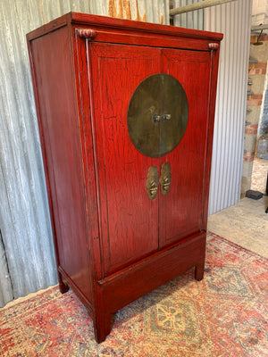 A red lacquered Chinese wedding cabinet