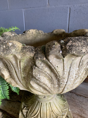 A pair of large tulip or acanthus pattern cast stone urns
