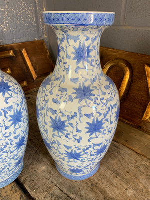 A pair of large hand painted blue and white Chinese vases