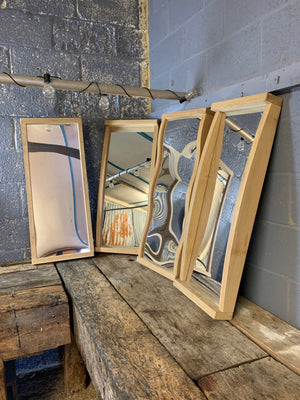 A set of four large fairground distortion mirrors