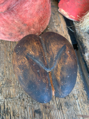 A carved wooden coco de mer specimen