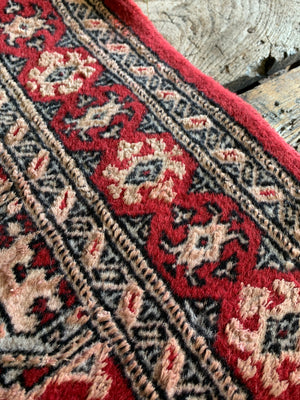 A hand woven Persian red ground rectangular rug