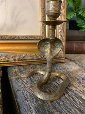 A pair of Indian or North African brass cobra candlesticks