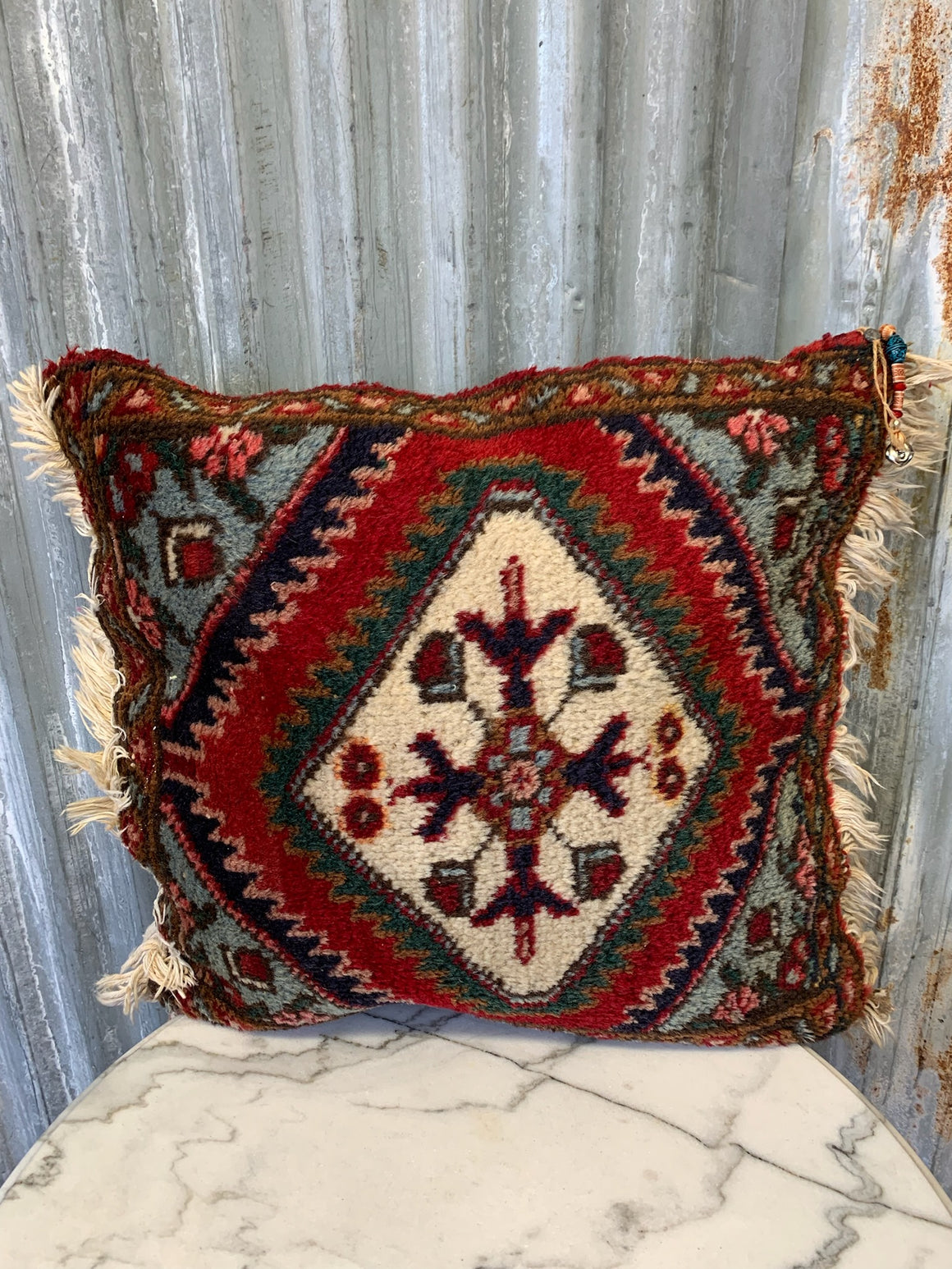 A large square Persian carpet cushion