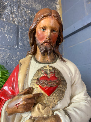 A large 25” plaster statue of Jesus with flaming Sacred Heart