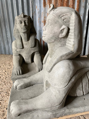 A pair of large cast stone Sphinx statues