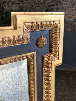 A black and gilt outset or box corner mirror