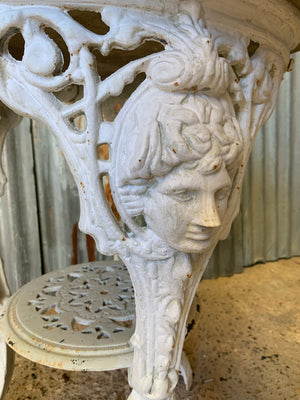 A white cast iron Britannia garden table with cast stone top