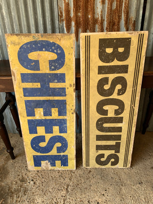 A pair of grocery shop advertising trade signs: cheese & biscuits