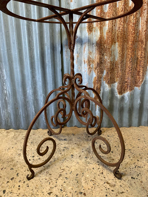 A cast iron garden table with marble top