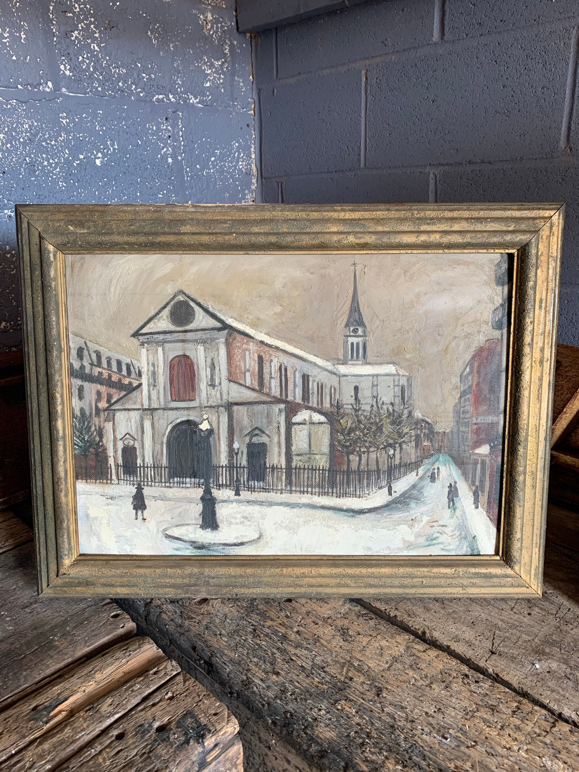 A large framed oil painting after Utrillo's "Notre Dame de Cligancourt"