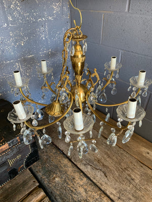 A heavily jewelled glass and brass 8 arm chandelier