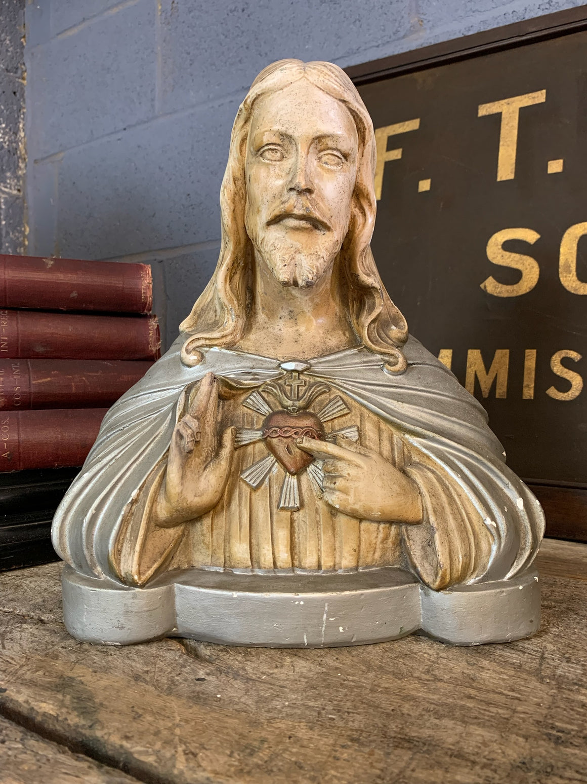 A plaster bust of Jesus with flaming Sacred Heart