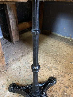 A black cast iron bistro table with marble top 2/3