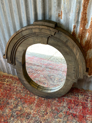 A large oeil de boeuf mirror