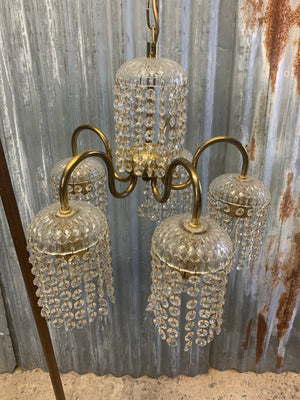 A five arm brass Hollywood Regency chandelier
