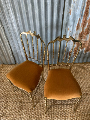 A pair of brass Chiavari chairs