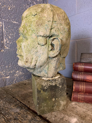 A life size weathered cast stone bust of a gentleman