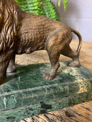A bronze lion on marble base after Barye