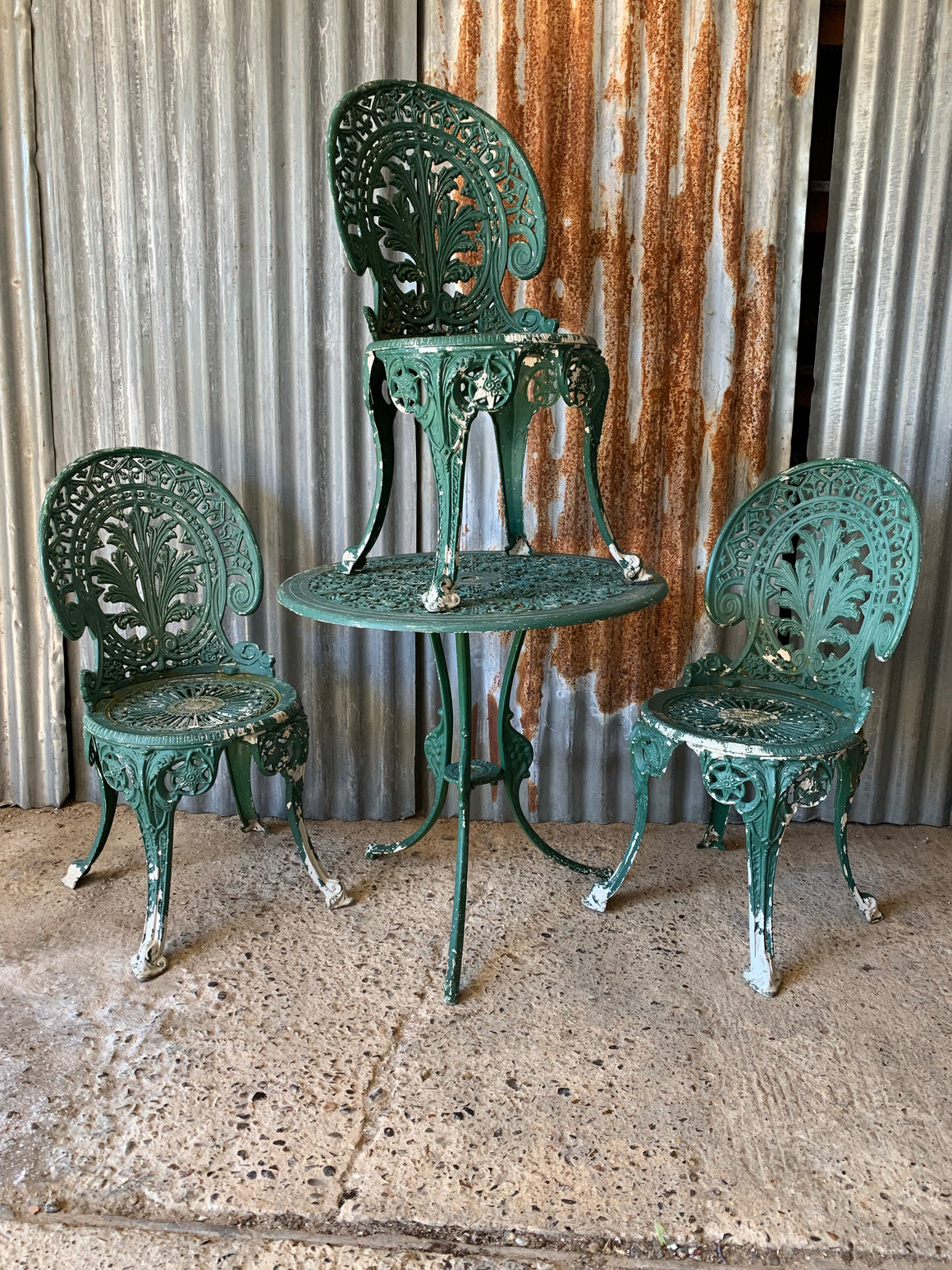 A green garden table and chairs set